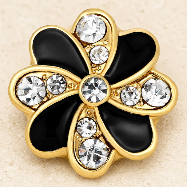 gold snap jewelry charm shaped like a flower with alternating black enamel and clear rhinestone petals