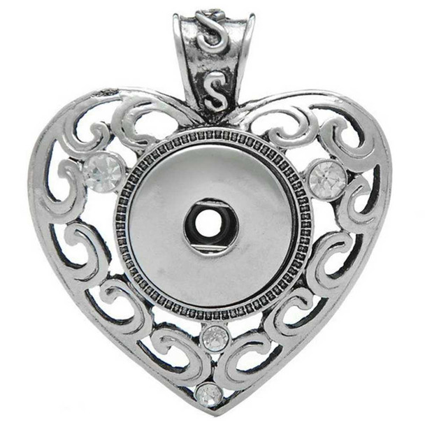 Silver heart-shaped SnapAccents snap jewelry pendant with intricate scrollwork design and clear rhinestone accents, featuring a central snap button base for interchangeable decorative snaps, perfect for customizable fashion accessories.