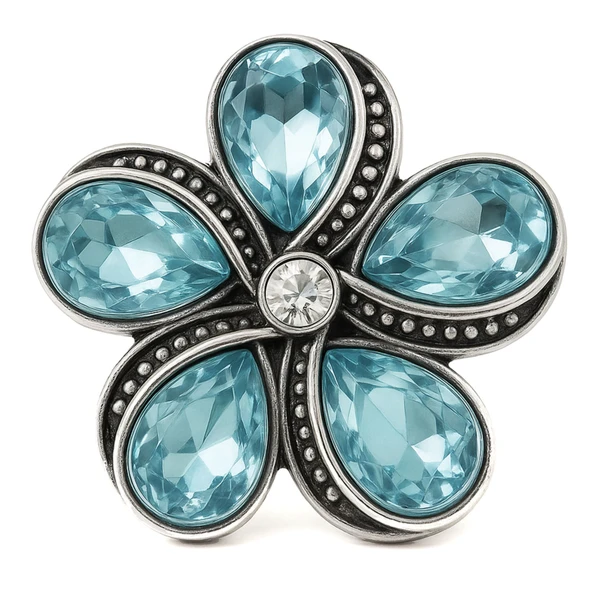 snap jewelry charm shaped like a flower with five light blue teardrop rhinestones and a clear rhinestone center set in vintage gray metal with beaded detailing