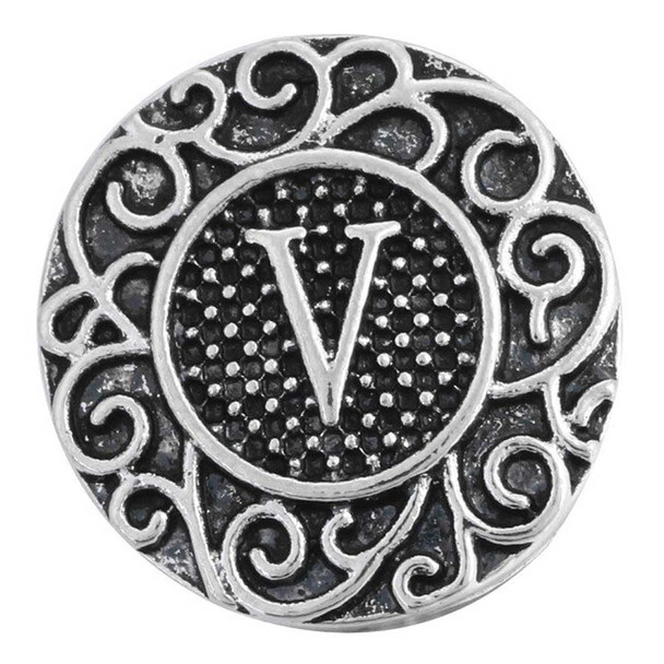 Vintage silver-tone SnapAccents snap charm with intricate scrollwork design and raised letter "V" center, textured background, perfect for customizable jewelry accessories.