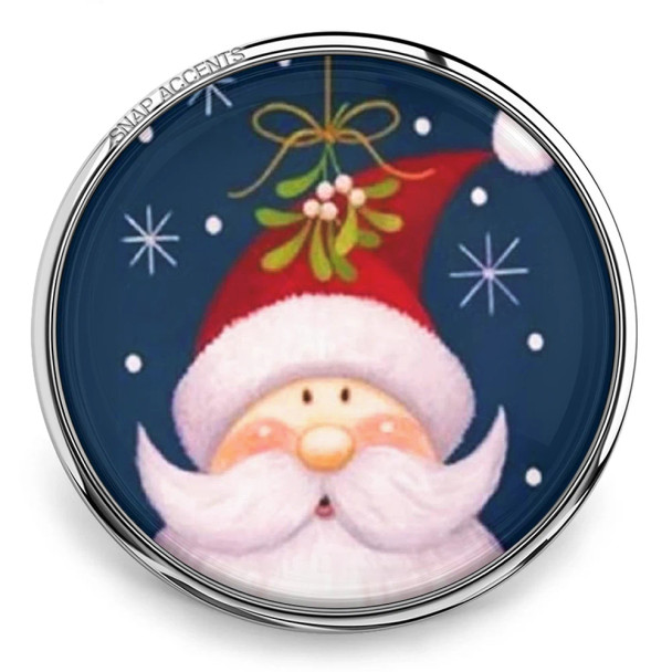 SnapAccents Christmas snap jewelry charm featuring a cute Santa Claus with rosy cheeks, white beard, red hat, and mistletoe on a dark blue background with snowflakes, perfect for holiday-themed interchangeable snap bracelets and accessories.