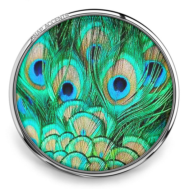 round snap jewelry charm with vibrant peacock feather design in green, blue, and brown tones set in a silver metal base