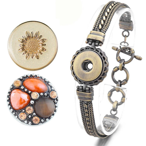 Antique bronze snap bracelet with intricate braided design and toggle clasp, paired with two interchangeable snap charms: one featuring a gold sunflower on a glittery beige background, and the other a round charm with orange and brown stones accented by small amber crystals, perfect for customizable snap jewelry lovers.