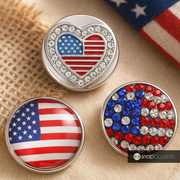 Patriotic SnapAccents snap jewelry set featuring American flag designs: heart-shaped rhinestone flag, classic flag dome, and red, white, blue rhinestone flag circle, perfect for customizable snap charm bracelets and accessories.