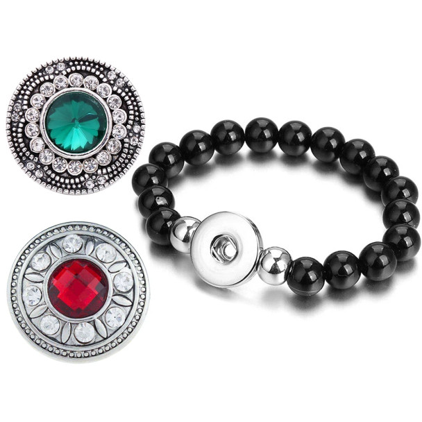 Black beaded snap bracelet with interchangeable decorative snap charms featuring green and red gem centers surrounded by clear rhinestones, stylish snap jewelry accessory for women.