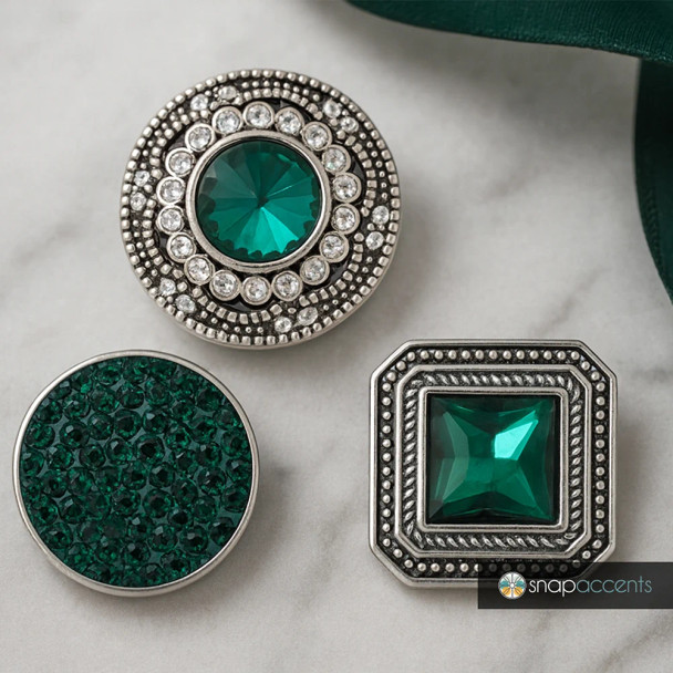 SnapAccents snap jewelry set featuring three interchangeable snap charms with emerald green crystals and antique silver-tone settings, including round and square designs, perfect for customizable bracelets, necklaces, and accessories.