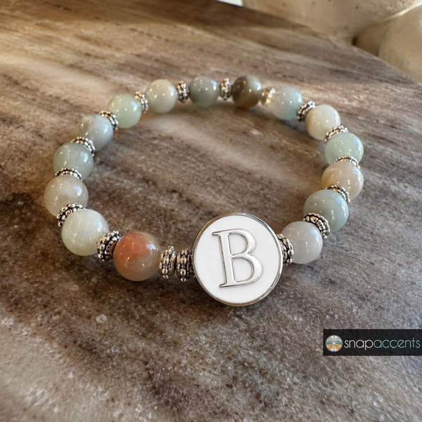 snap jewelry bracelet with round multicolored beads and a white snap charm featuring a silver letter B