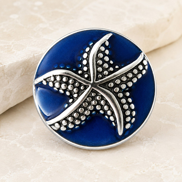 18mm snap jewelry charm with a silver-tone textured starfish on a deep blue enamel background
