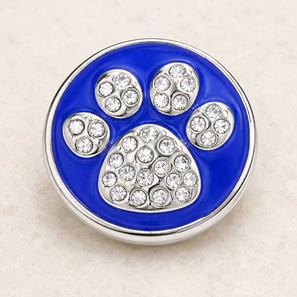round snap jewelry charm with a blue enamel background and a silver dog paw design studded with clear rhinestones