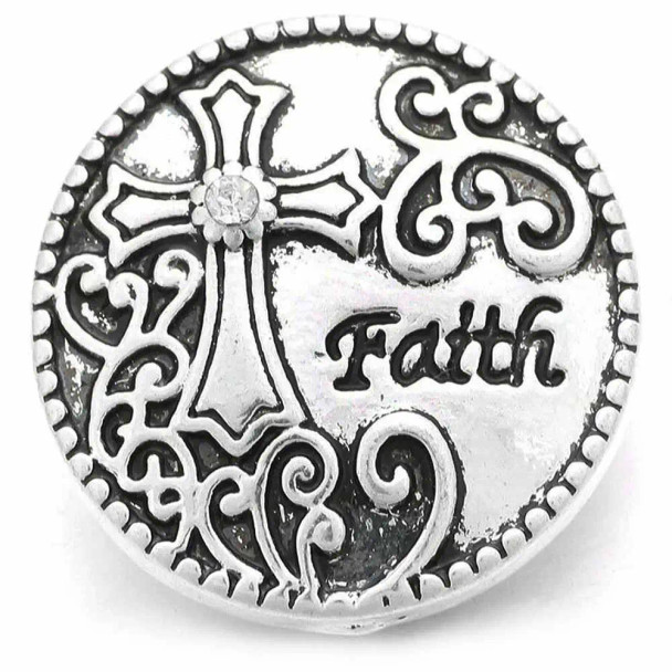 Silver SnapAccents snap charm featuring an ornate cross with a clear rhinestone center, decorative scrollwork, and the word "Faith" engraved on a heart-shaped background, perfect for interchangeable snap jewelry bracelets and necklaces.