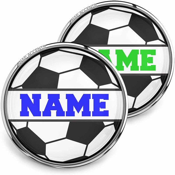 SnapAccents customizable snap jewelry featuring black and white soccer ball design with bold blue and green "NAME" text, interchangeable decorative charm for bracelets, personalized sports-themed accessory, perfect for soccer fans and athletes, high-quality glass dome snap button, ideal gift for kids and adults.
