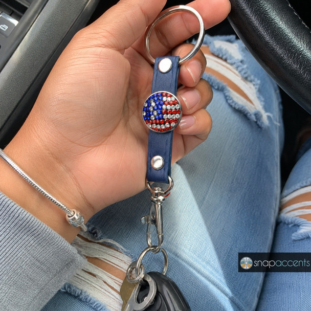 snap jewelry keychain with a blue leather strap and a round American flag snap charm made of red, white, and blue rhinestones