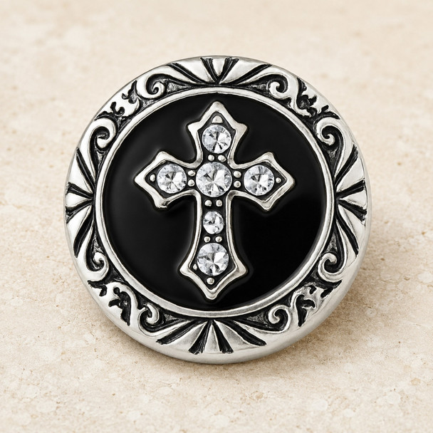 round snap jewelry charm with a black background, silver-tone ornate border, and a rhinestone-studded Celtic cross in the center