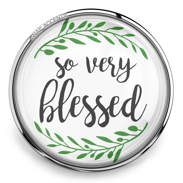 Round SnapAccents snap jewelry charm with "so very blessed" text in elegant script, surrounded by green leafy accents, silver metal frame, inspirational accessory for bracelets or necklaces.