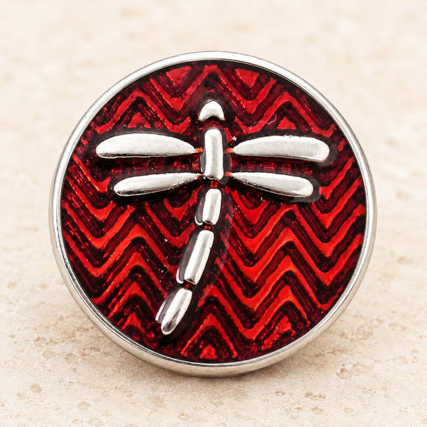 round snap jewelry charm with a silver dragonfly on a red chevron enamel background