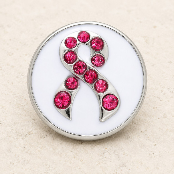 round snap jewelry charm with a white enamel background and a silver ribbon adorned with pink rhinestones