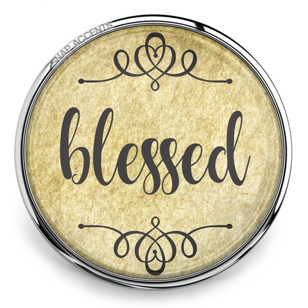 SnapAccents round snap jewelry charm with vintage beige background and elegant black script text "blessed," decorative swirls, silver metal frame, interchangeable snap button accessory for bracelets and necklaces.