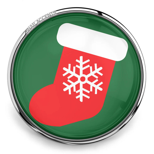 SnapAccents Christmas stocking snap charm with red stocking, white cuff, and white snowflake design on green background, silver metal frame, festive holiday jewelry accessory.