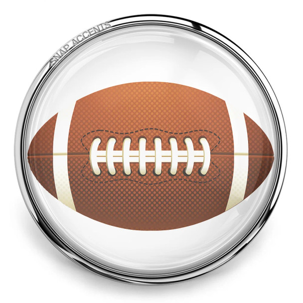 SnapAccents round snap jewelry charm featuring a detailed American football design with brown textured surface, white laces, and stripes, set in a shiny silver metal frame, perfect for sports fans and football-themed accessories.