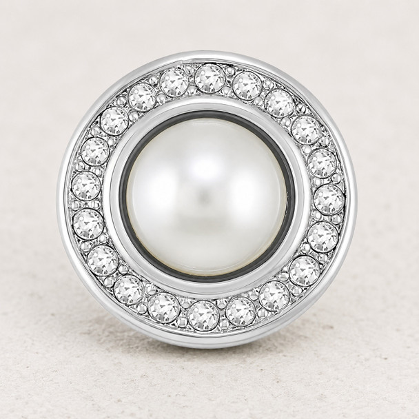 round snap jewelry charm with a central white pearl surrounded by a circle of clear rhinestones in a silver-tone setting