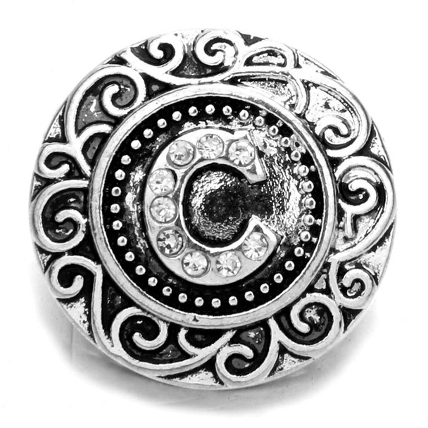 Silver SnapAccents snap jewelry charm with ornate scrollwork design and rhinestone-studded letter "C" centerpiece, decorative interchangeable button for bracelets and accessories, vintage-inspired fashion statement piece.