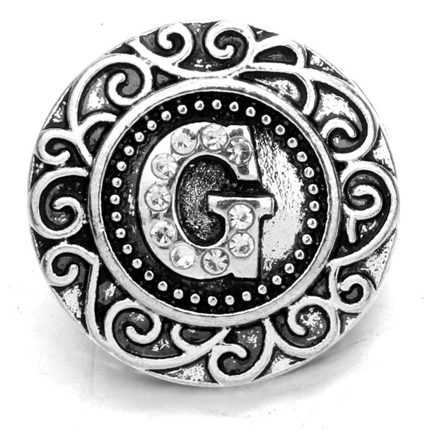 Silver SnapAccents snap charm with ornate swirl design and rhinestone-studded letter G centerpiece, decorative interchangeable jewelry accessory for bracelets and necklaces, vintage-inspired personalized snap button charm.
