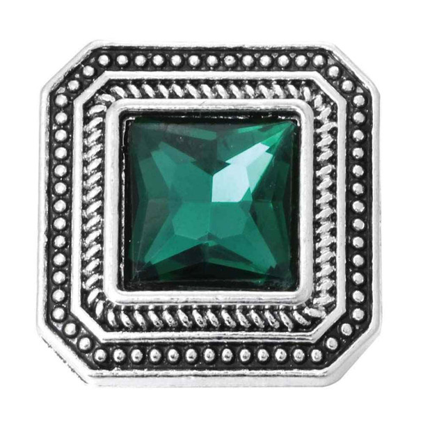 square snap jewelry charm with a faceted green stone center and detailed silver-toned beaded and twisted rope frame