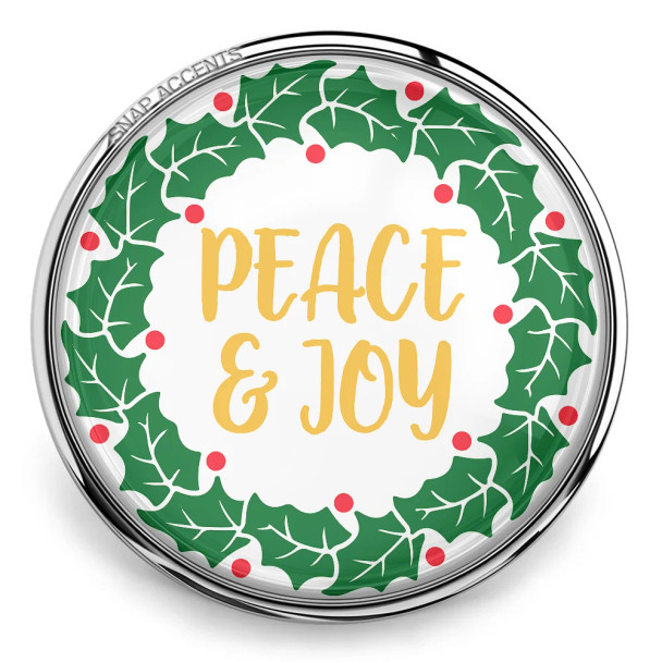 SnapAccents holiday snap jewelry charm featuring green holly leaves with red berries wreath design and gold "Peace & Joy" text, festive Christmas accessory for interchangeable snap jewelry.