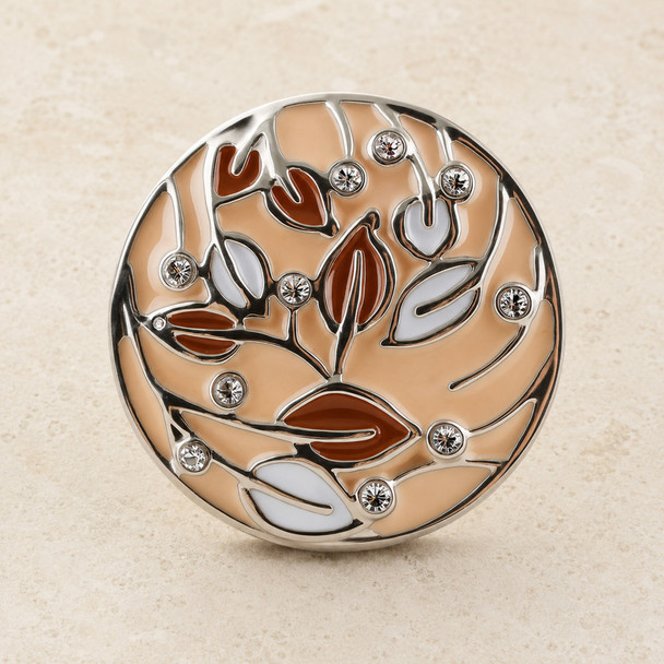 round snap jewelry charm with beige enamel background, brown and white leaf designs, and clear rhinestone accents