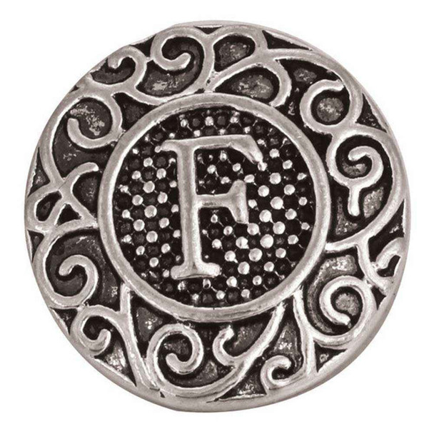 round silver snap jewelry charm with a raised letter F in the center and intricate filigree scrollwork around the edge