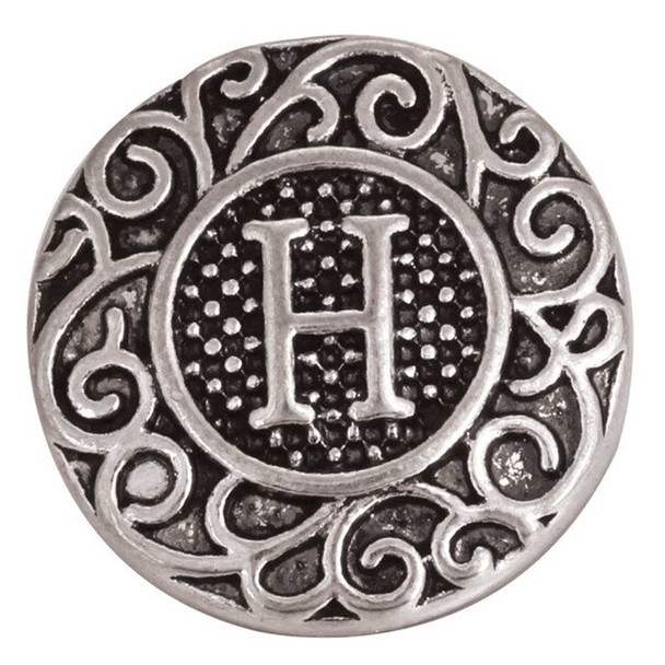 Antique silver snap charm with ornate scrollwork design and raised letter H in the center, decorative round metal jewelry accent for interchangeable snap bracelets and accessories.