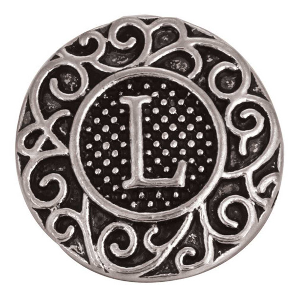 Round silver SnapAccents snap jewelry charm with intricate scrollwork design and raised letter "L" in the center on a textured black background, perfect for personalized interchangeable bracelets and accessories.