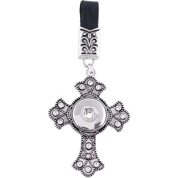 Silver-tone ornate cross snap jewelry charm with clear rhinestones, attached to black leather strap with decorative metal clasp, designed for interchangeable snap buttons.