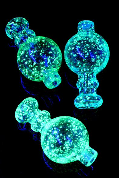 Glow-in-the-dark frit glass carb cap in assorted colors, bubble profile with small handle; flat-top banger compatible accessory for head-shop wholesale pages.
