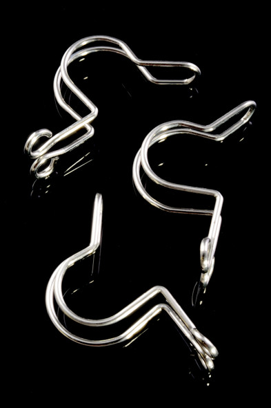 Three reflective metal keck s-clips on black backdrop, 18.8 mm size for securing glass joints in retail smoke gear displays.