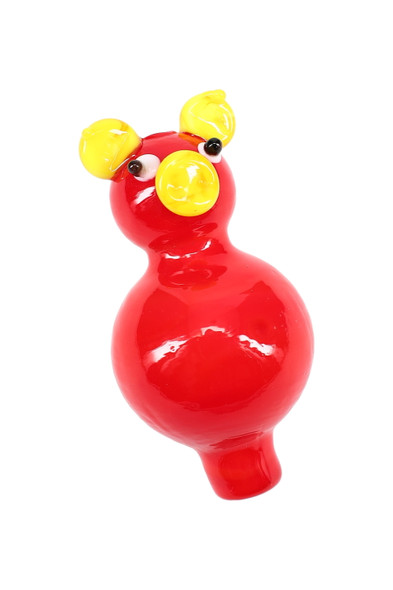 Red glass pig bubble carb cap with yellow ears and snout on white; wholesale dab accessory for smoke shops.