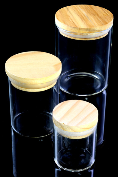 Wholesale glass jars with bamboo pop-top lids, three sizes grouped front view on black background for retail display
