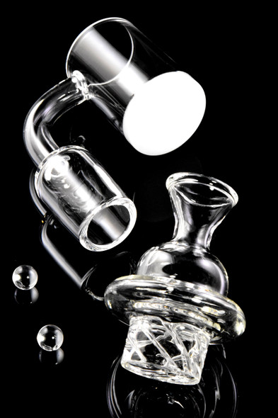 Quartz spinner banger with white bottom, turbine cap, and two 6 mm beads, head-shop supply, angled studio shot on black.