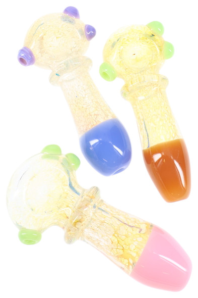 4.5" fumed color-changing glass spoon pipes with neon pink, blue, and amber tips, green marble grips; overhead studio view for wholesale head-shop catalogs
