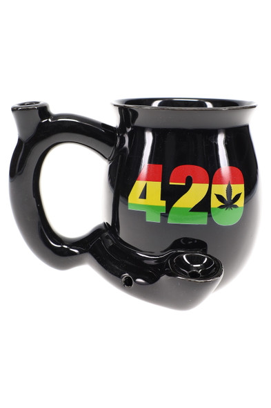 Black 11 oz ceramic mug pipe for wholesale novelty shelves, Rasta 420 print with leaf icon, built-in bowl on front and carb on handle, studio view. Black 11 oz ceramic mug pipe for wholesale novelty shelves, Rasta 420 print with leaf icon, built-in bowl on front and carb on handle, studio view.