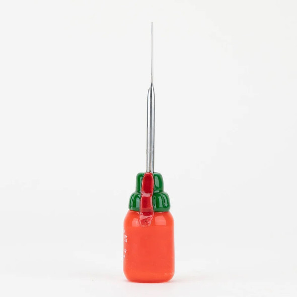 Head-shop supplies upright sriracha glass dabber front view, green cap atop orange bottle, 4.5-inch steel rod centered