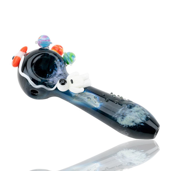 Front three-quarter studio view of glossy galaxy spoon with planet marbles and astronaut; compact 4.5" hand pipe for wholesale head-shop displays.