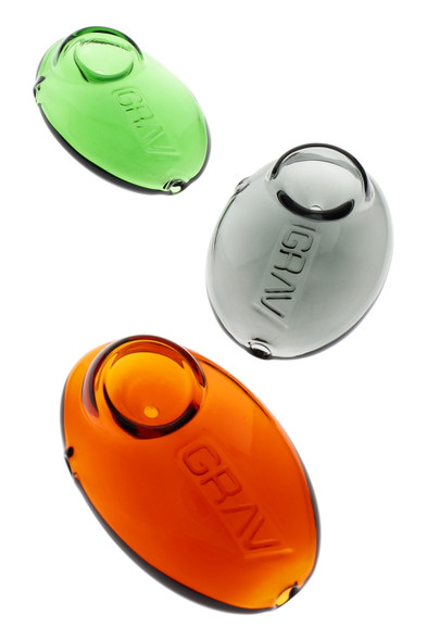 Wholesale 3-inch GRAV Pebble Spoon glass hand pipes in green, smoke grey and amber borosilicate, overhead trio product shot on white background.