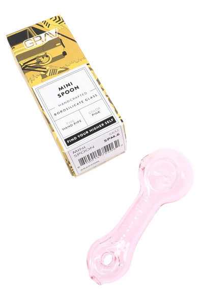 Pink GRAV mini spoon hand pipe beside branded retail box, borosilicate glass, overhead studio view for wholesale listings.