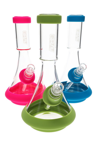 Wholesale 9.5-inch GRAV Deco beaker with silicone base and mouth rings, clear glass; green, pink and blue skins shown in front trio angle.