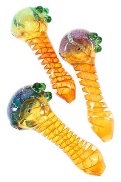 Top view of three 4.5" gold-fumed color-changing spoon pipes with spiral necks, frit/striped bowls, and green marble grips for wholesale head shops. Top view of three 4.5" gold-fumed color-changing spoon pipes with spiral necks, frit/striped bowls, and green marble grips for wholesale head shops.
