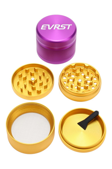 Wholesale 63 mm EVRST 4-part aluminum grinder, purple cap with gold internals, disassembled top-down view showing sifting screen and scraper tool.