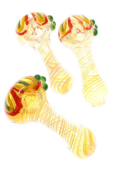 Three 4" thick color-changing rasta flower spoon pipes with green marble grips and spiral necks, clear/yellow glass—studio top view for wholesale head-shops. Three 4" thick color-changing rasta flower spoon pipes with green marble grips and spiral necks, clear/yellow glass—studio top view for wholesale head-shops.