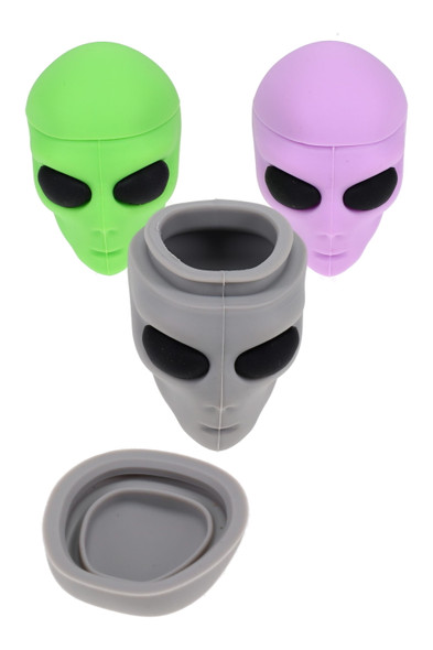 Wholesale silicone alien head concentrate jars, gray open container with lid removed beside green and purple closed units, studio overhead angle
