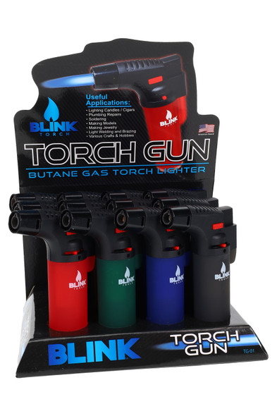 12-piece Blink Torch Gun lighters counter display for wholesale, assorted red/green/blue/black tanks, front-left angle with header card.